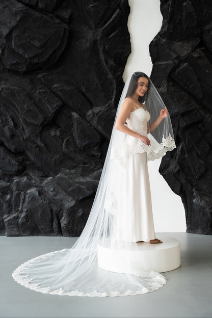Ivory two-tier wedding veil with delicate lace trim edging